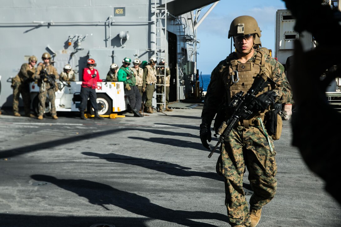 ATLANTIC OCEAN (February 26, 2018) U.S. Marines assigned to the Maritime Raid Force (MRF), 26th Marine Expeditionary Unit (MEU), prepare to board an MH-60S Sea Hawk, attached to Helicopter Sea Combat Squadron (HSC) 28, during fast rope training aboard the Wasp-class amphibious assault ship USS Iwo Jima (LHD 7), Feb. 26, 2018. Iwo Jima and the 26th MEU are conducting naval operations in the U.S. 6th Fleet area of operations. (U.S. Marine Corps photo by Cpl. Jered T. Stone/Released)