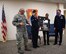 Col. Aaron Greenspan (left), the Aerospace Medicine Squadron commander, helps his Airmen present a shadow box of personal military history to retiring Lt. Col. John Crowe (far right), who said farewell to Scott Air Force Base on Feb. 11, 2018.  Crowe served as a flight surgeon fro the 932nd Medical Group's Aerospace Medicine Squadron from 2013 to February 2018.  (U.S. Air Force photo by Lt. Col. Stan Paregien)