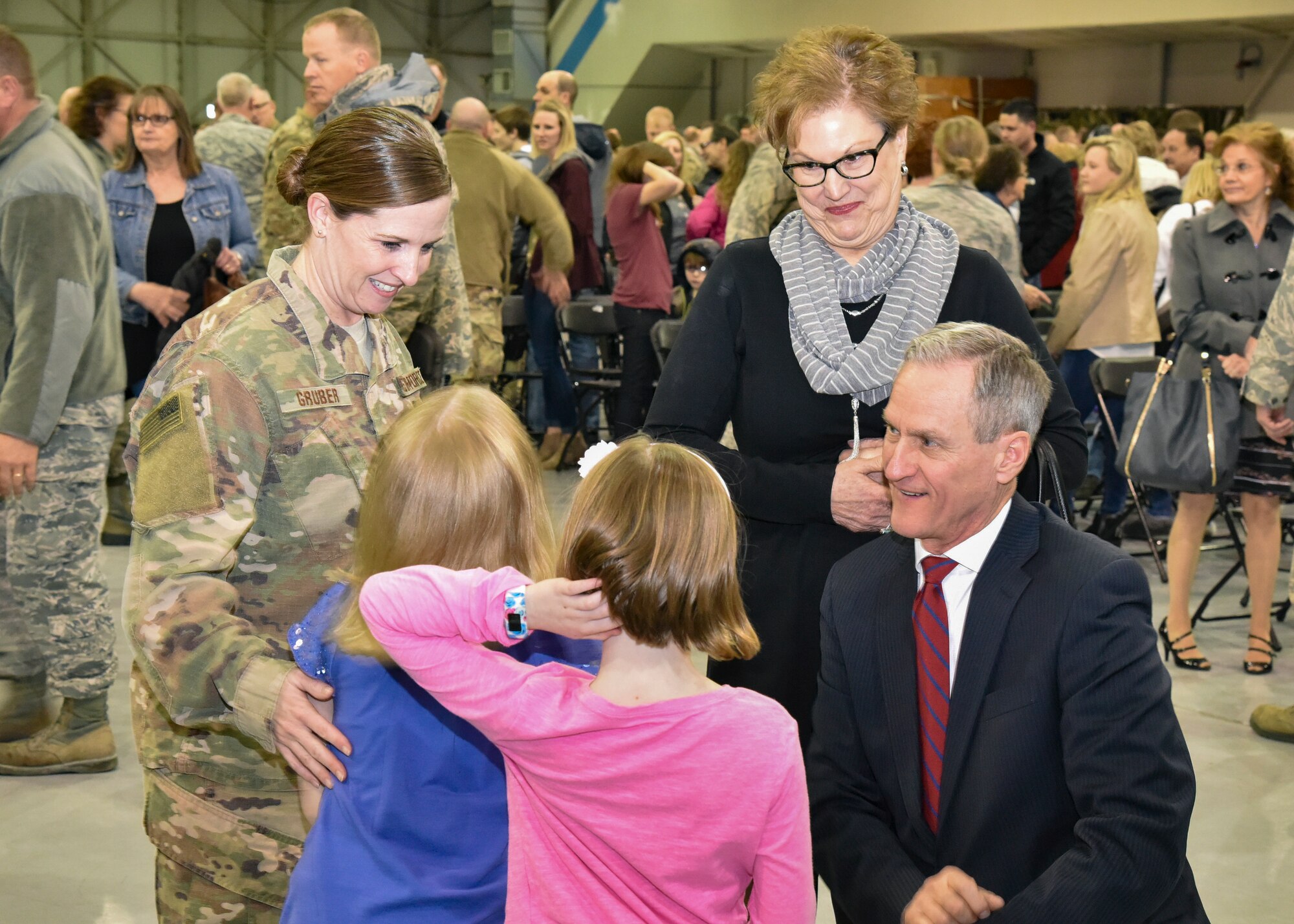 Master Sgt. Nichole Gruber, 114th Civil Engineer Squadron first sergeant, and her family visits with South Dakota Governor Dennis Daugaard and First Lady Linda during a welcome home ceremony March 4, 2018 at Joe Foss Field.