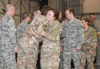 Staff Sgt. Hunter Roberts, 114th Security Forces member, is congratulated by South Dakota’s top leadership during a welcome home ceremony March 4, 2018 at Joe Foss Field.