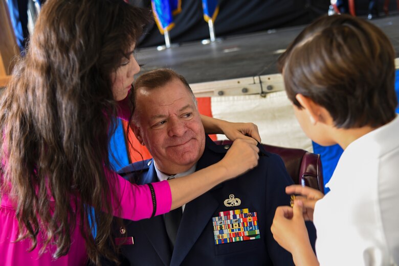 Col. Leo J. Kamphaus, Jr.’s family pins the rank of colonel on his uniform during a ceremonial promotion ceremony held during the 920th Rescue Wing’s monthly Unit Training Assembly at Patrick, Air Force Base, Florida, March 3. The honor was immediately followed by another formality recognizing his new role as the 920th Maintenance Group commander. (U.S. Air Force photo by Senior Airman Brandon Kalloo Sanes)