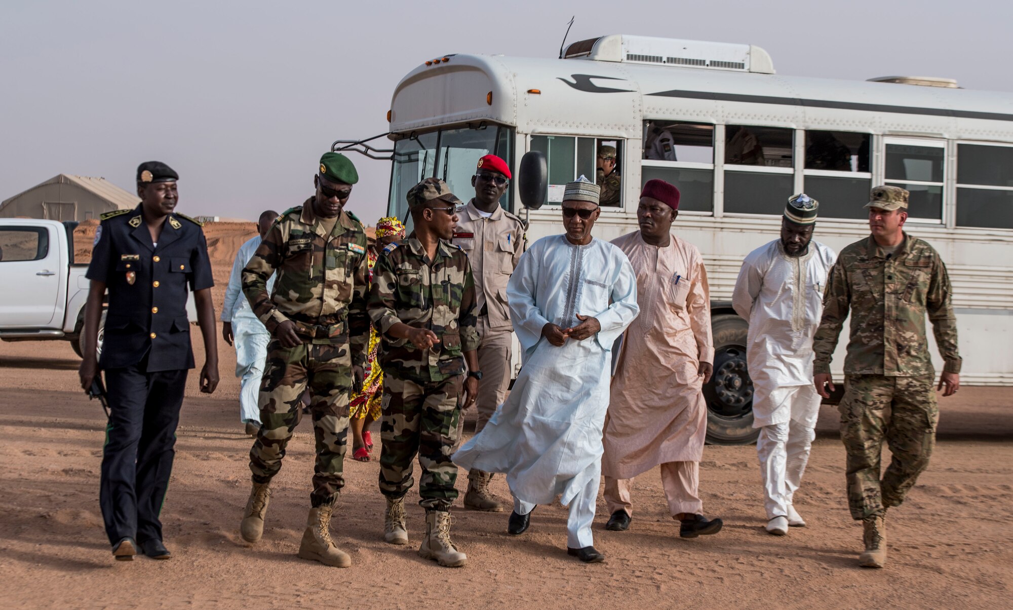 Agadez civic leaders, commanders of the Forces Armées Nigeriennes and U.S. Air Force squadron commanders from the 409th Air Expeditionary Group walk together during a base tour Feb. 21, 2018, at Nigerien Air Base 201, Niger. Sustaining positive relations with their host-nation partners is part of a unique mission that promotes regional stability and prosperity. (U.S. Air Force photo by Tech. Sgt. Nick Wilson)