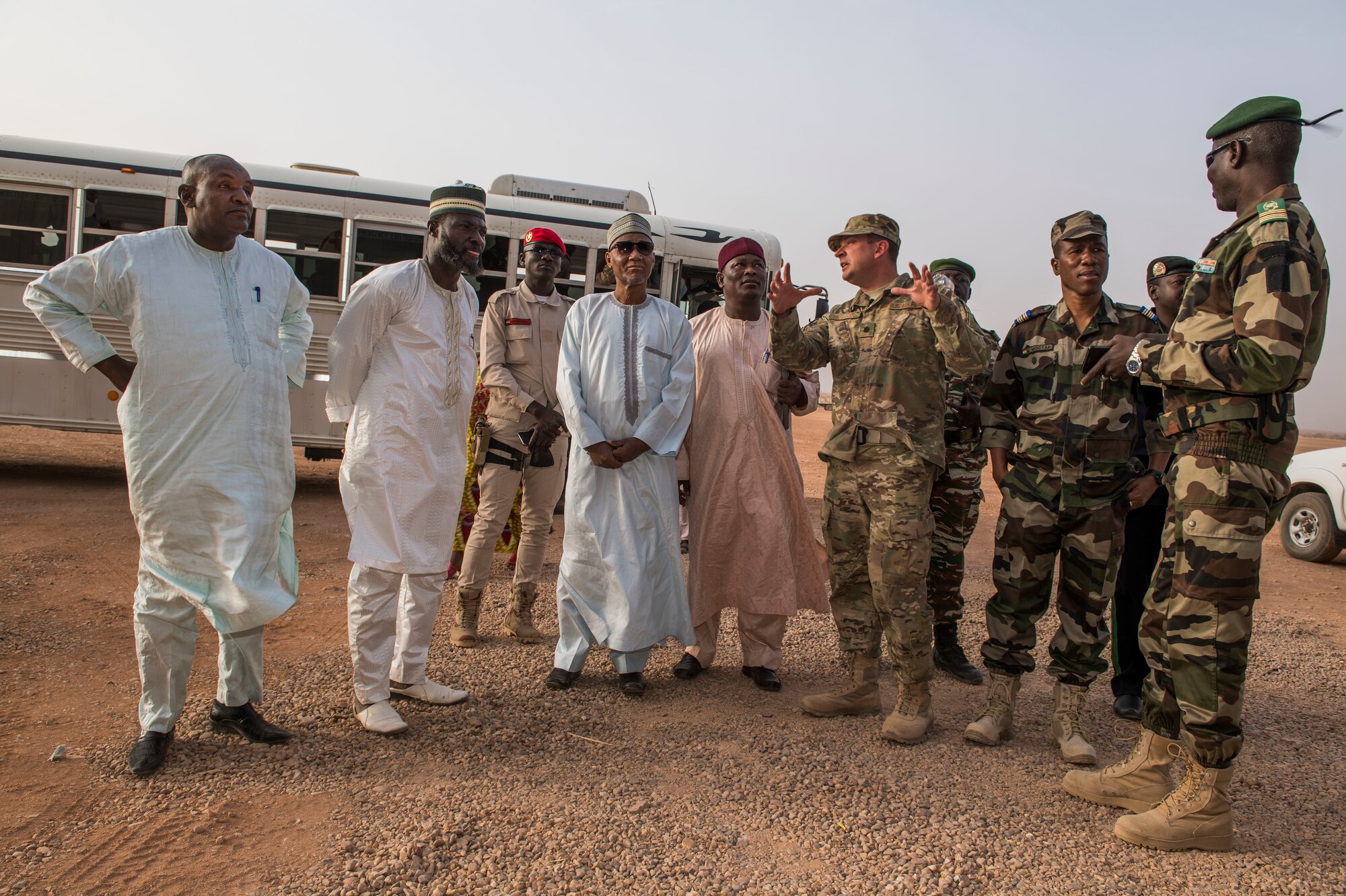 U.S. Air Force Lt. Col. Brad Harbaugh, 724th Expeditionary Air Base Squadron commander, gives commanders of the Forces Armées Nigeriennes and Agadez civic leaders a tour of base construction projects Feb. 21, 2018, at Nigerien Air Base 201, Niger. Harbaugh used the tour to discuss with civic leaders how integrated capabilities and interoperability promote regional partnerships. (U.S. Air Force photo by Tech. Sgt. Nick Wilson)