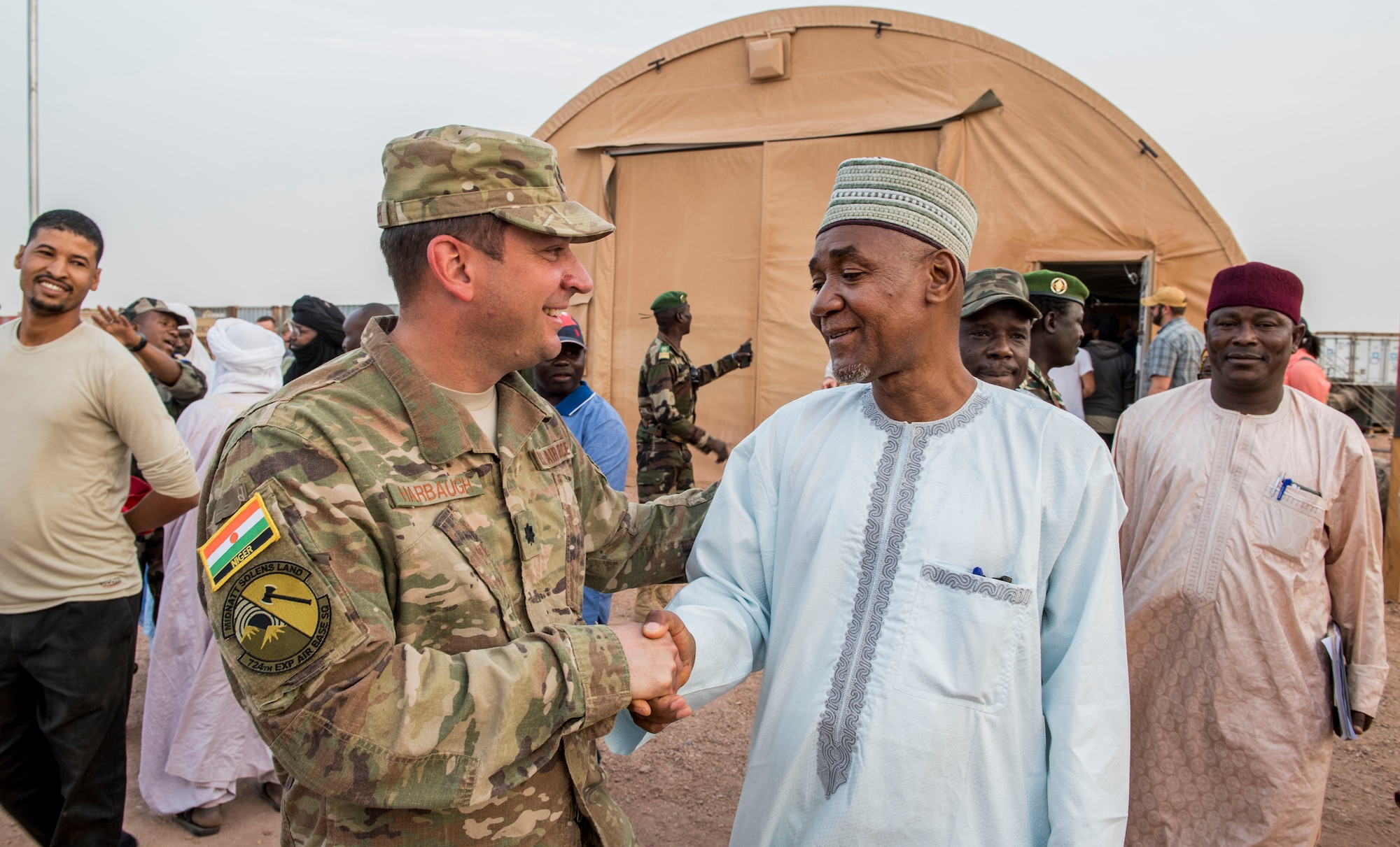 Lt. Col. Brad Harbaugh, 724th Expeditionary Air Base Squadron commander, shakes hands with the Agadez Region Governor, Saadou Soloke, after a base tour Feb. 21, 2018, at Nigerien Air Base 201, Niger. Harbaugh gave Soloke and his delegation a tour of construction projects on the base and discussed mutual goals and objectives between the U.S. and Niger. The U.S. and Niger seek to eliminate mutual security threats in areas where assistance is requested, and these operations are conducted in full coordination with the host nation. (U.S. Air Force photo by Tech. Sgt. Nick Wilson)