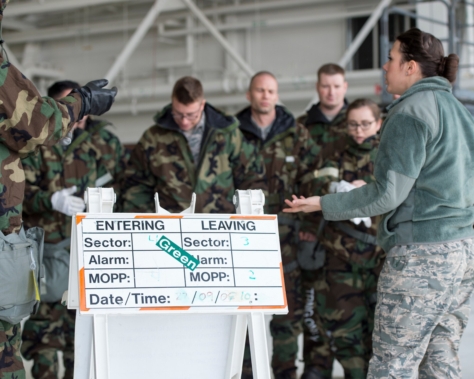 U.S. Air Force Airman 1st Class Morgan Johnson, right, with the 133rd Civil Engineer Squadron, reviews the different Mission Oriented Protective Posture or MOPP levels in St. Paul, Minn., Feb. 24, 2018.