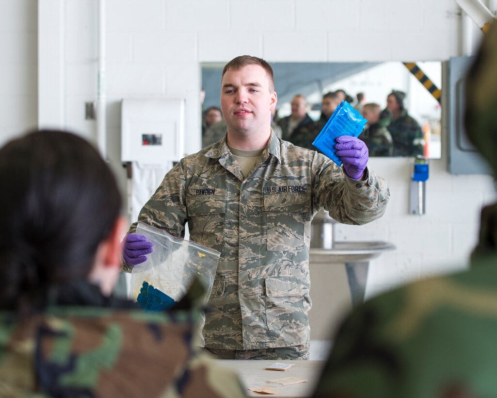 U.S. Air Force Senior Airman Alex Bawden, with the 133rd Civil Engineer Squadron, teaches a class on chemical detection and personal decontamination equipment in St. Paul, Minn., Feb. 24, 2018.