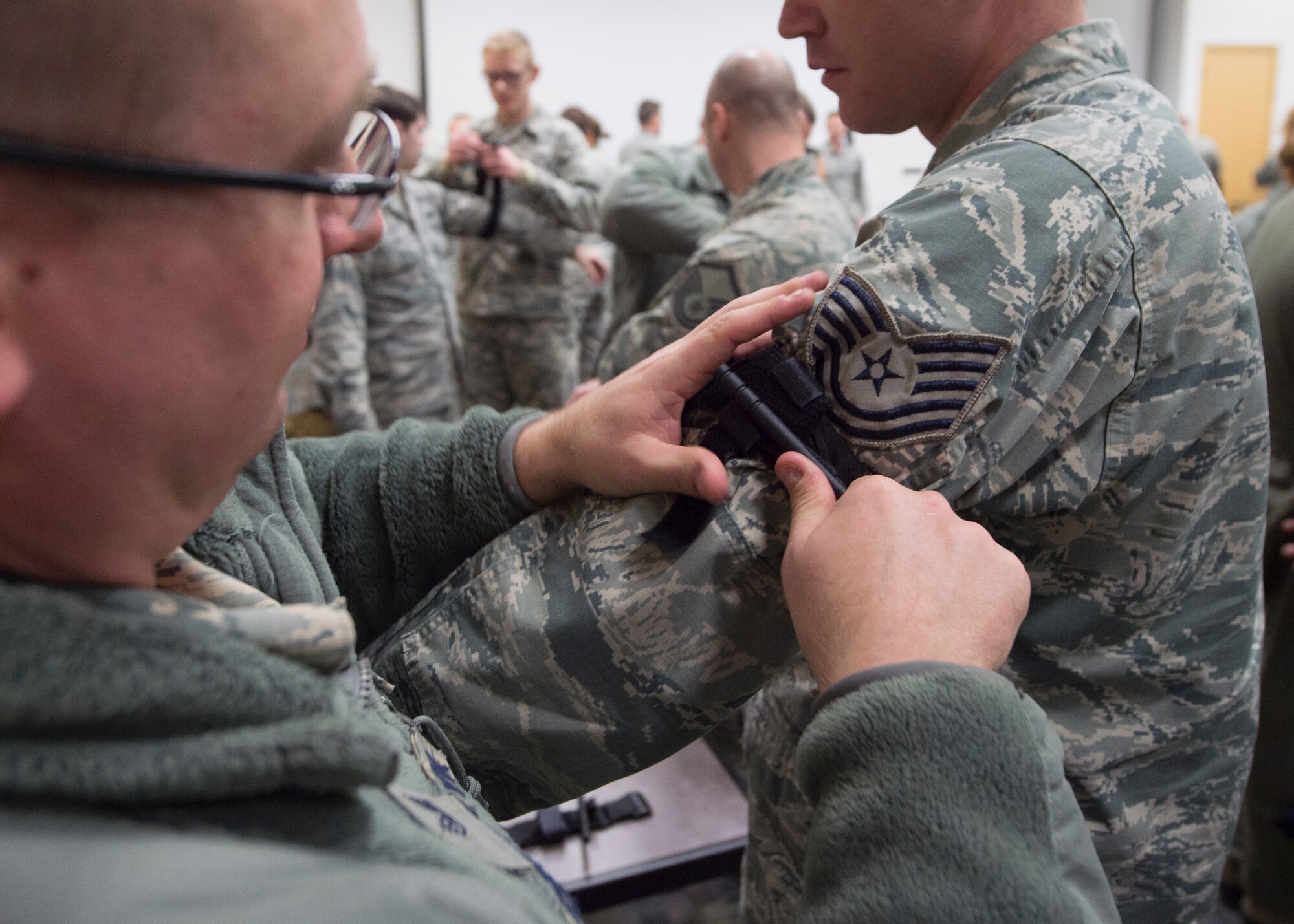 U.S. Air Force Airmen with the 133rd Airlift Wing partake in a self-aid buddy care class St. Paul, Minn., Feb. 24, 2018.