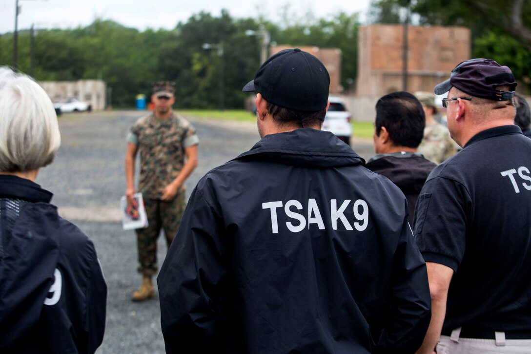 A Marine gives a training brief to Marine military working dog handlers and Transportation Security Administration agents.
