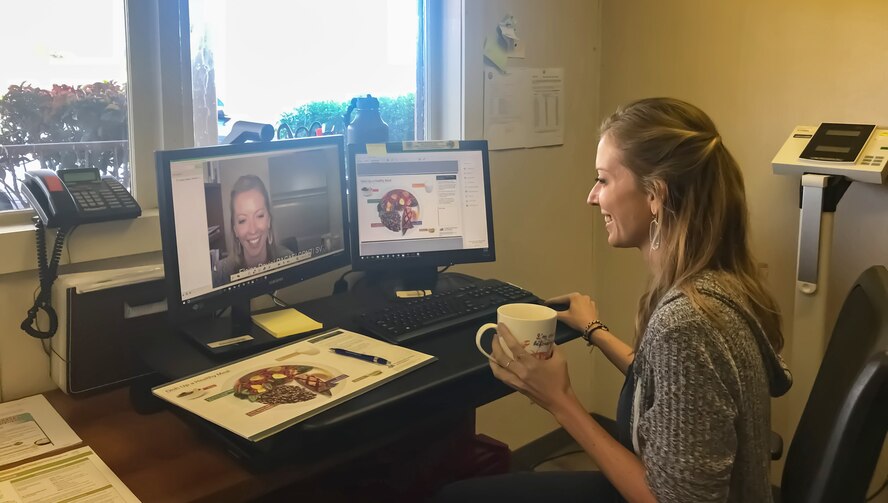 Elaine Davis, a registered dietician at Joint Base Pearl Harbor-Hickam, Hawaii, is preparing for a tele-medical nutrition therapy appointment with a patient at Eielson Air Force Base, Alaska on Feb. 6, 2018. Using a video teleconference, patients have access to dieticians anywhere, and can get vital information in disease management and preventative care. (U.S. Air Force photo)