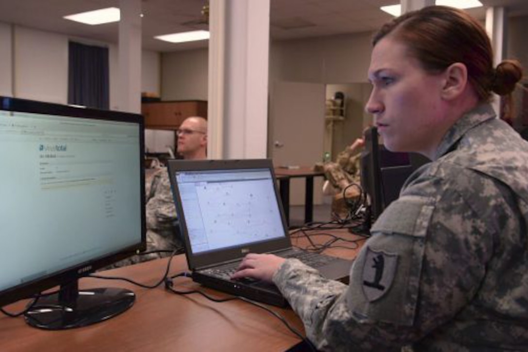 Missouri Army National Guard 1st Lt. Kristi Cook at her computer.