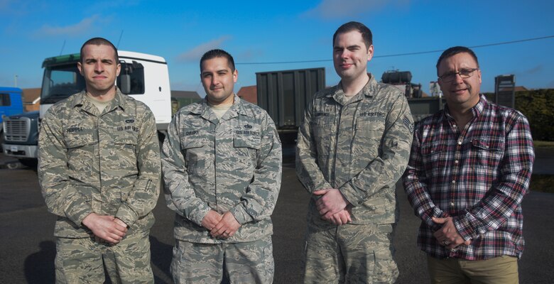 Three U.S. Air Force Airmen and a civilian assigned to the 100th Logistics Readiness Squadron pose for a photograph at RAF Mildenhall, England, March 5, 2018. The team of four were tasked to drive more than 500 miles through a snow storm to collect 30 tons of anti-icing product for the airfield. Their efforts, along with a team of Airmen involved in logistics planning, allowed the RAF Mildenhall airfield to remain operational during the storm.  (U.S. Air Force photo by Senior Airman Justine Rho)