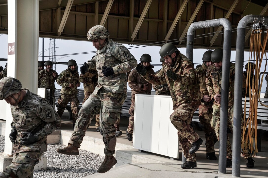 U.S. and Italian soldiers conduct airborne door exit training.