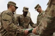 A flag detail from the 40th Brigade Engineer Battalion folds an aging Kuwaiti Flag