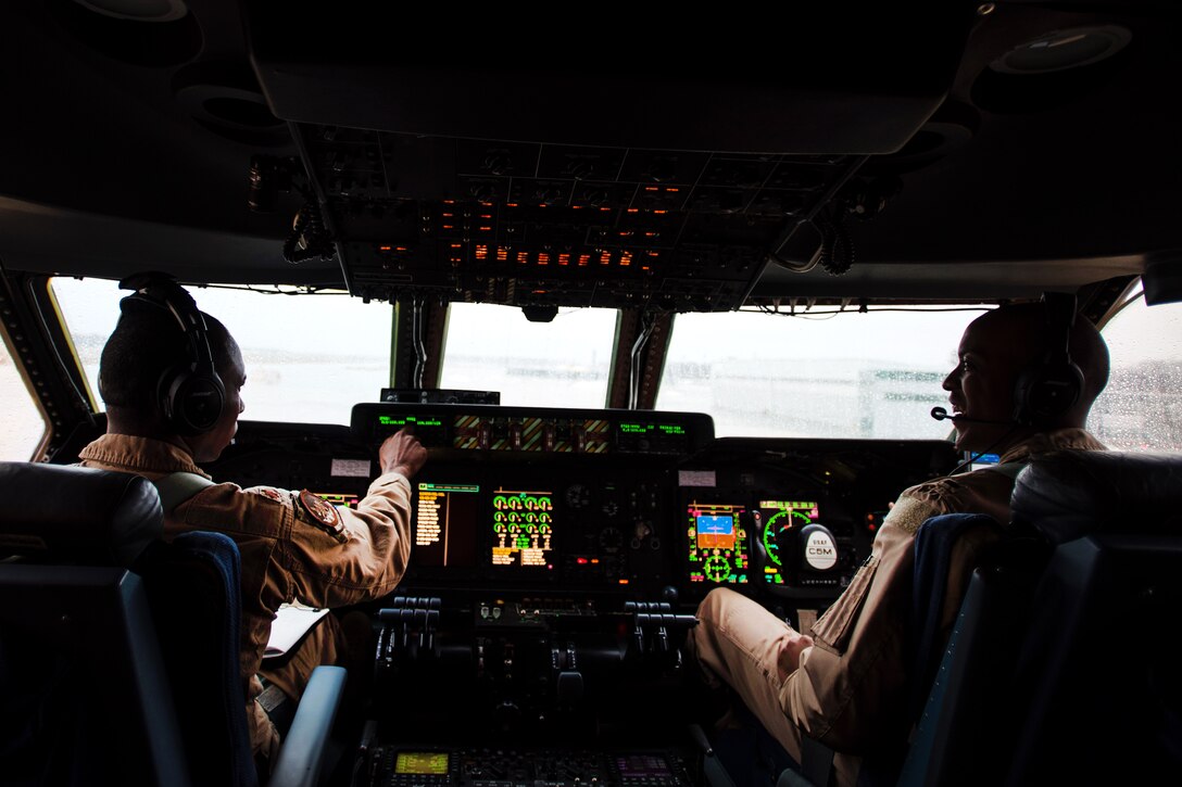 Pilots prepare for takeoff in a C-5M Galaxy aircraft.
