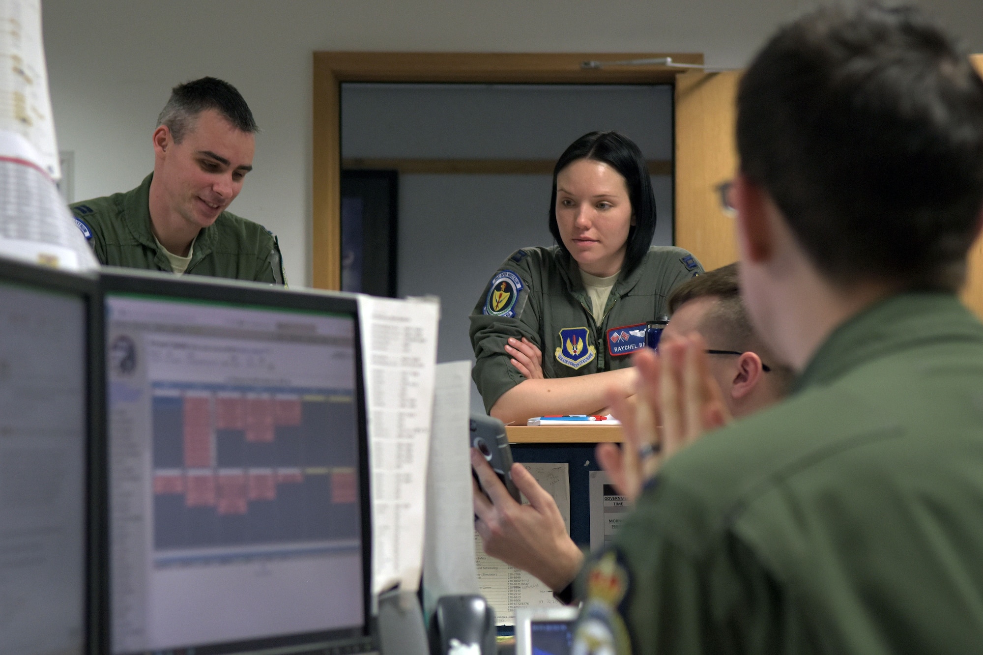 U.S. Air Force Capt. Raychel Bates, center, 351st Air Refueling Squadron assistant “A” flight commander, discusses the process of building aircrews for the exercise on RAF Mildenhall, England, Feb. 26, 2018. Aircrews are comprised of two pilots and a boom operator, who conducts the refueling. (U.S. Air Force photo by Airman 1st Class Benjamin Cooper)