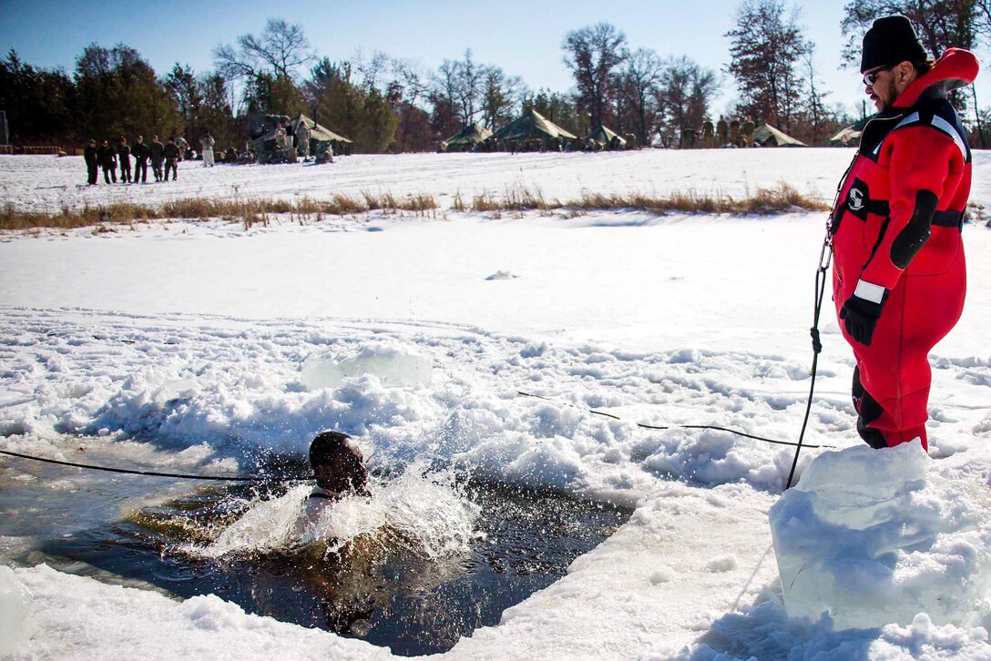 Gunnery Sgt. Justin R. Mike jumps into freezing water as part of cold-water immersion training.