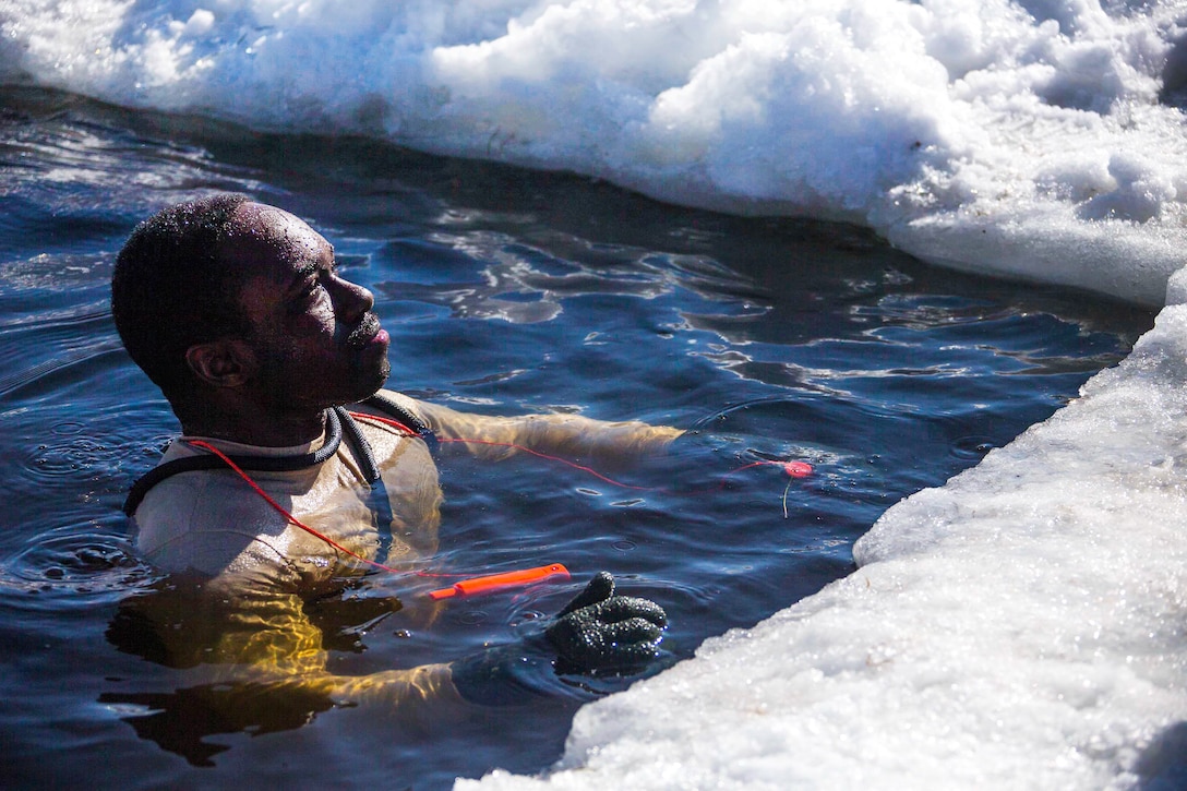 Gunnery Sgt. Justin R. Mike stands in freezing water as part of cold-water immersion training.