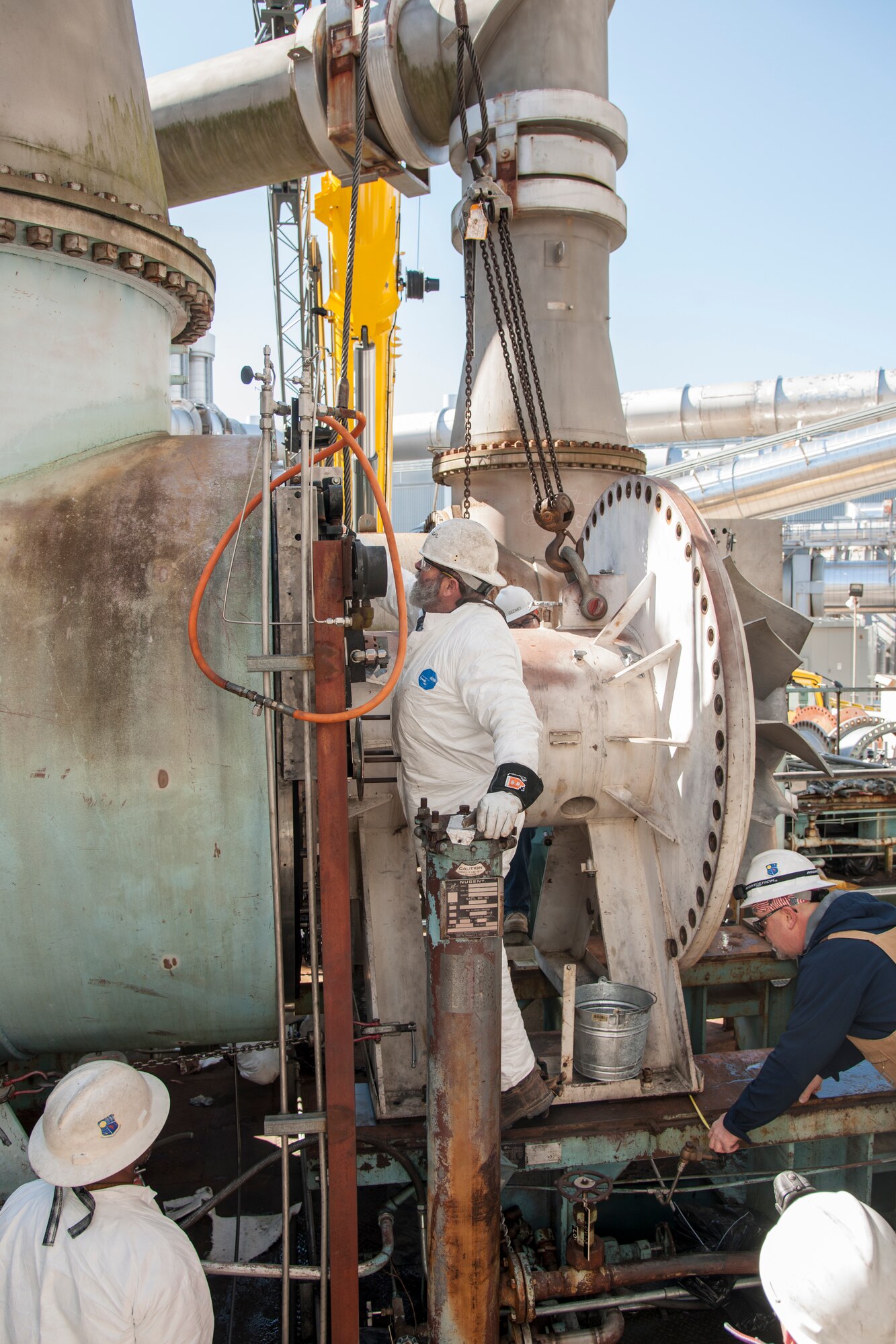 AEDC craft personnel perform maintenance on the C-Plant Turbine Chiller 3 (TC3) at the Aeropropulsion Systems Test Facility for test support of the C-2 engine test cell at Arnold Air Force Base. Chiller units like TC3 enable altitude testing in the C1 and C2 engine test cells. In addition to the crane and ironworker support from the AEDC Model and Machine Shop, those involved in completing the work include: outside machinists David Brooks, Steve Cowan and John Meeks and boiler makers Scott Murphy and Stevie Sullivan. (U.S. Air Force photo/Jacqueline Cowan)