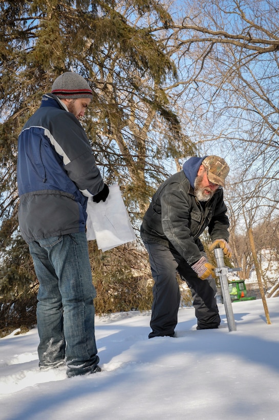 two men survey snow