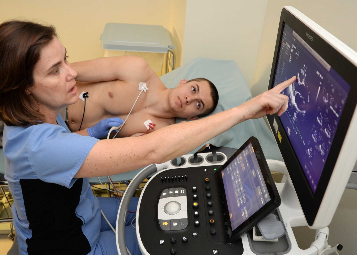 Suzanne Packard, a Cardiology Phase II instructor at Wilford Hall Ambulatory Surgical Center, explains a cardio sonogram to Trenton Moore, Basic Military Training trainee at Joint Base San Antonio-Lackland, Texas, during the Basic Military Training Fast Track program Feb. 28, 2018. The 59th Medical Wing’s weekly program gives trainees in BMT technical school on cardiology-related medical hold a singular location to have their issues tested and identified.