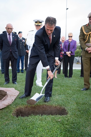 Ambassador Scott Brown covers stones from the Taranaki region of New Zealand and Pearl Harbor, Hawaii, with soil at a ceremony preparing the U.S. monument at Pukeahu National War Memorial, New Zealand for construction.