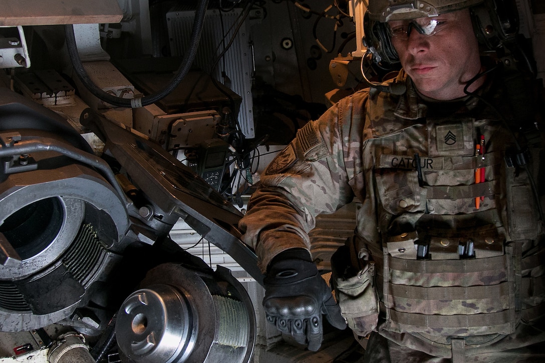 A soldier listens to the radio for instructions.