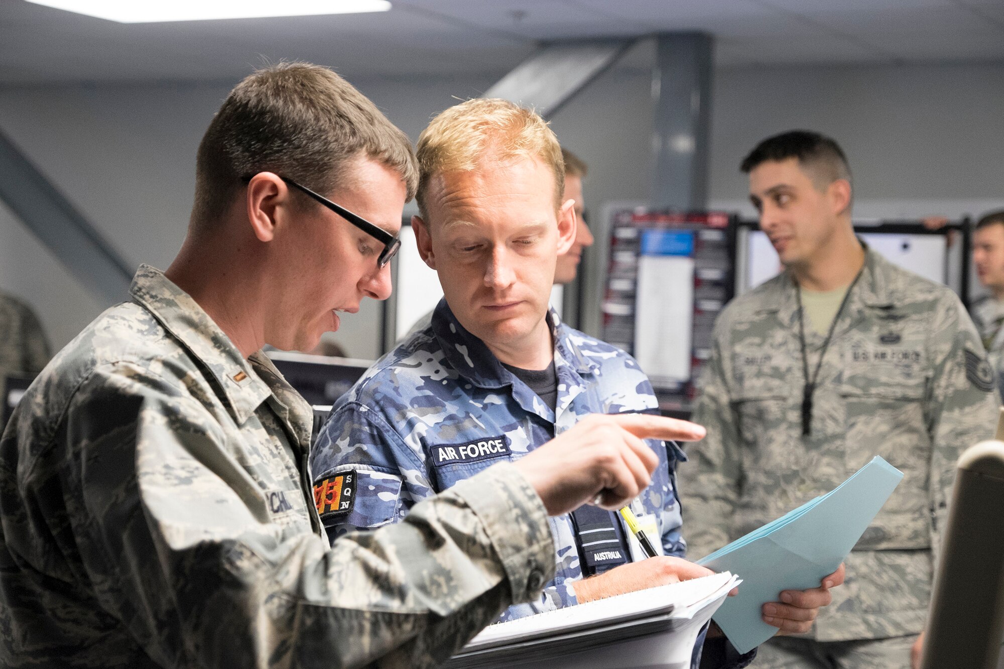 Cyber Mission Defense Team personnel from Scott review documents during Red Flag 18-1.