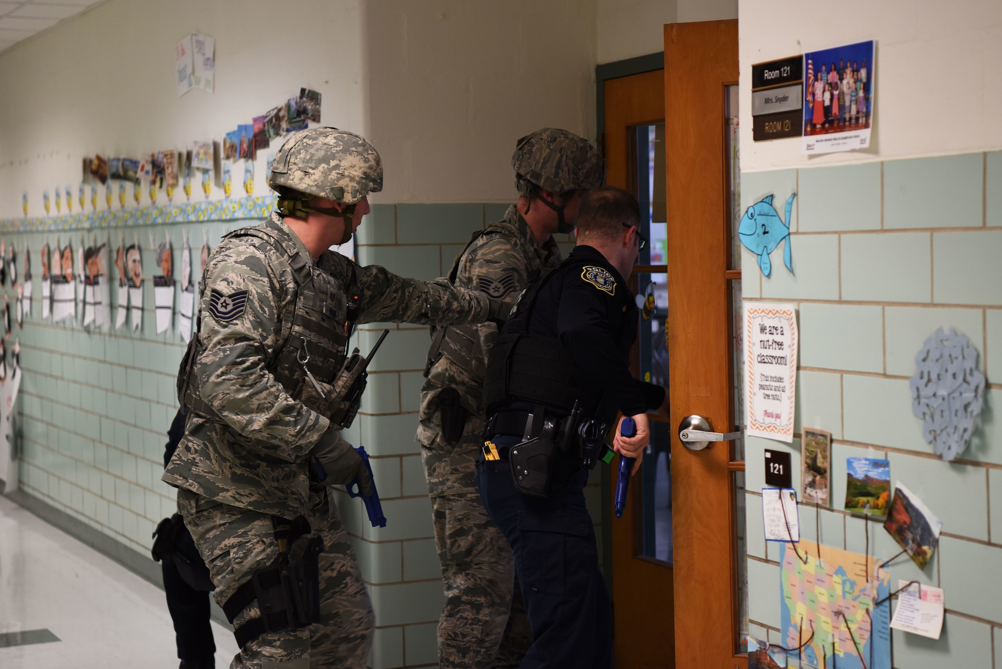 From the left, Tech. Sgt. Adam Paini, 436th Security Forces Squadron, Staff Sgt. Brandon Trapp, 436th SFS, and Officer Justin Viens, 436th SFS supervisory police officer, clear rooms during an active shooter exercise Feb. 26, 2018, at the George S. Welch Elementary School and Dover Air Force Base Middle School at Dover AFB, Del. The 436th Inspector General office evaluated school faculty and Security Forces on their response procedures. (U.S. Air Force photo by Airman 1st Class Zoe M. Wockenfuss)