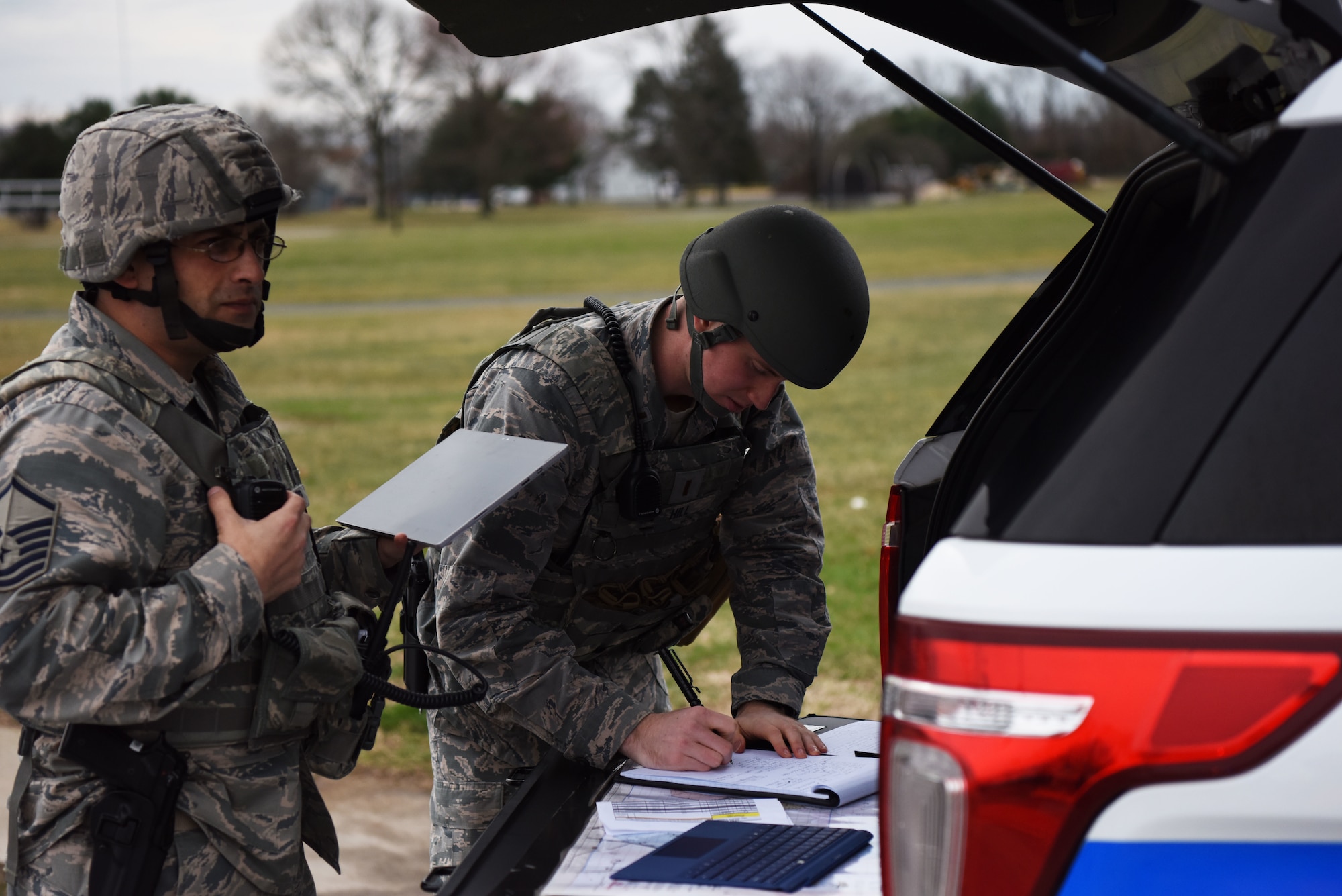 Master Sgt. Brett Snyder (left), 436th Security Forces Squadron, and 2nd Lt. Henry Hill, 436th SFS, maintain on-scene command and control of their responding forces during an active shooter exercise at the George S. Welch Elementary School and Dover Air Force Base Middle School Feb. 26, 2018, at Dover AFB, Del. A key part of the exercise was to ensure Security Forces and school faculty understood each other’s roles in the event of a real world incident. (U.S. Air Force photo by Airman 1st Class Zoe M. Wockenfuss)