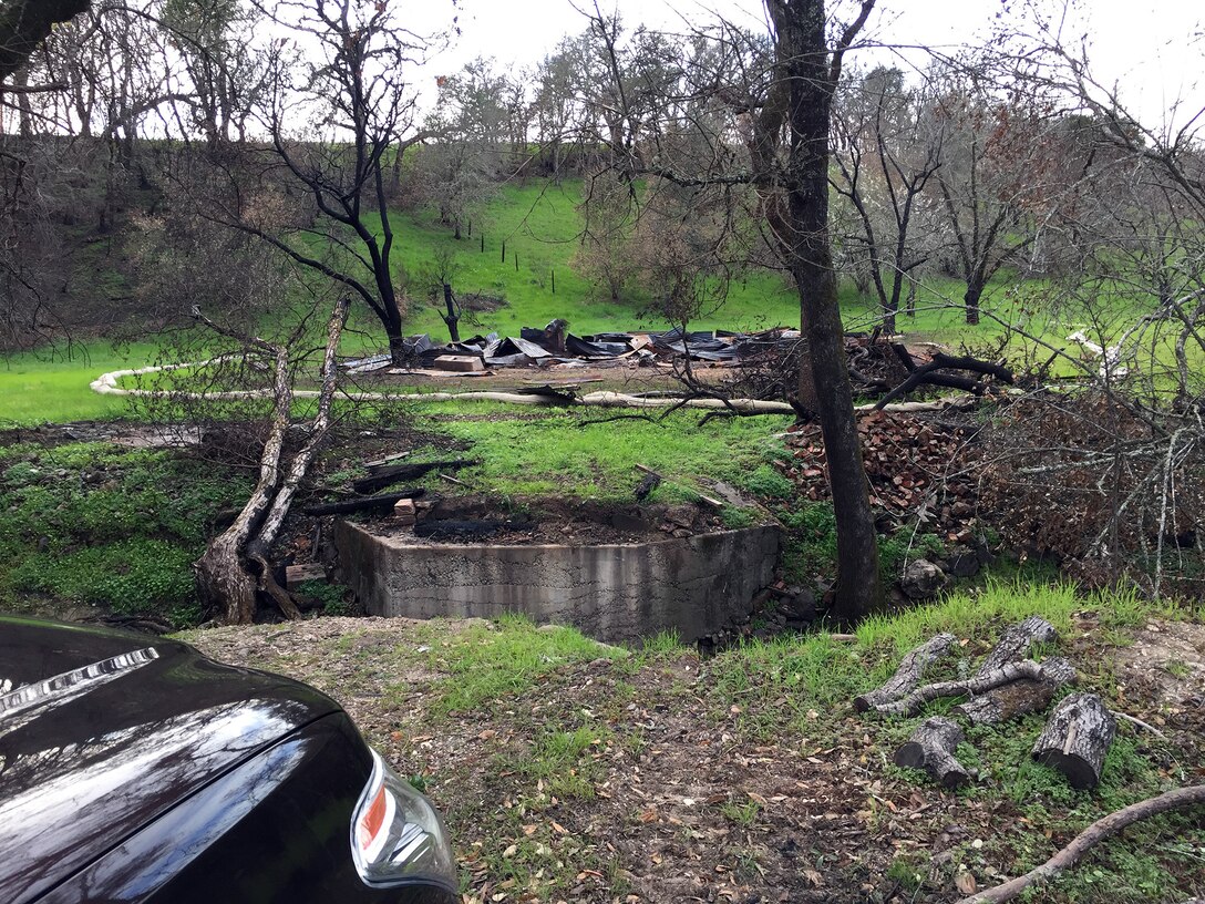 This property in Sonoma County had a small bridge that burned during the wildfire. The Corps of Engineers was able to find an alternate route to reach the parcel and have the debris removed. (U.S. Army photo by J. Paul Bruton/Released)