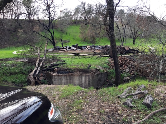 This property in Sonoma County had a small bridge that burned during the wildfire. The Corps of Engineers was able to find an alternate route to reach the parcel and have the debris removed. (U.S. Army photo by J. Paul Bruton/Released)