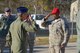 Fourth Air Force commander Maj. Gen. Randall A. Ogden (foreground left) returns a salute after presenting Tech. Sgt. Jerod Simmons (right) with a challenge coin March 3, 2018, at the combat arms training and maintenance center at Joint Base Charleston, S.C. Ogden recently visited the 315th Airlift Wing where he met with Airmen to talk progress and innovation. (U.S. Air Force photo by 1st Lt. Rashard Coaxum)