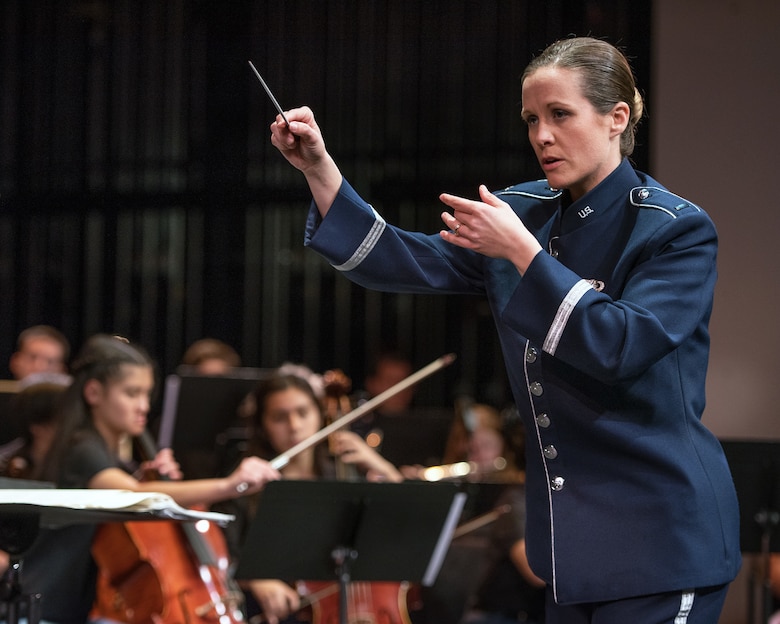 U.S. Air Force 1st. Lt Christina Muncey, conductor with the Band of the West, Lackland Air Force Base, Texas, leads the Napa Valley Youth Symphony during their performance with the rock music group “Mobility” of The United States Air Force Band of the Golden West, Travis Air Force Base, Calif. at the Veteran’s Home in Yountville, Calif., March 4, 2018. The band and symphony are performing together after the original concert, scheduled in October 2017, was canceled due to devastating wildfires in Napa and Sonoma counties. (U.S. Air Force photo by Louis Briscese)