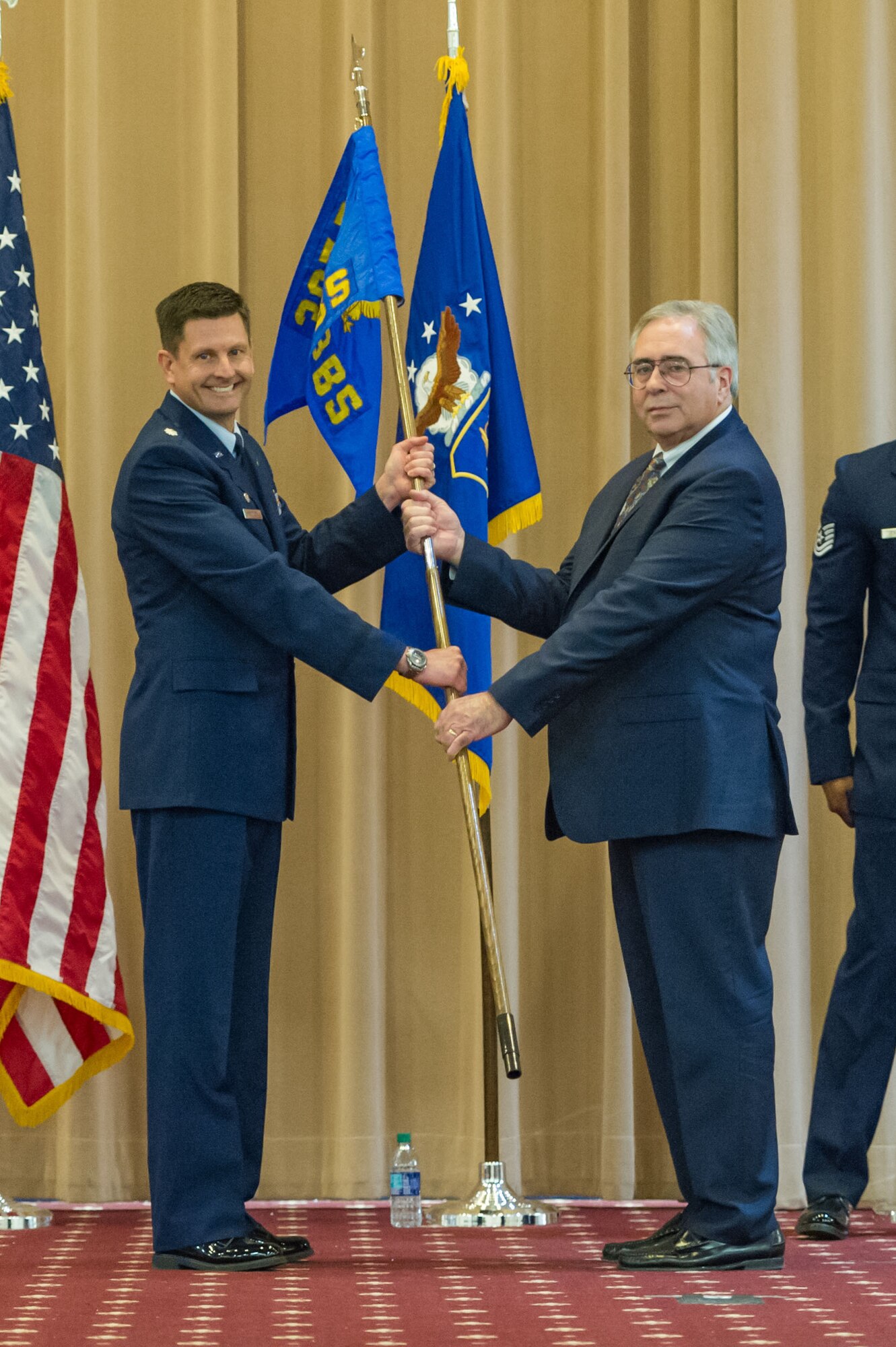 George Carroll III, president of Experimental Aircraft Association Chapter 343, shares the 343rd Bomb Squadron guidon from Lt. Col. John Booker, commander of the 343rd BS, during an honorary commander’s induction ceremony at Barksdale Air Force Base, Louisiana, March 3, 2018.