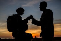 U.S. Marines with 1st Reconnaissance Battalion, 1st Marine Division, fist bump each other prior to a low level static line (LLSL) parachute operations at Marine Corps Base Camp Pendleton, Calif., Feb. 1, 2018