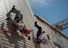 Firefighters from the 96th Civil Engineer Group rappelled from the top of their new structural training facility to cut the ribbon marking its official opening here March 1.