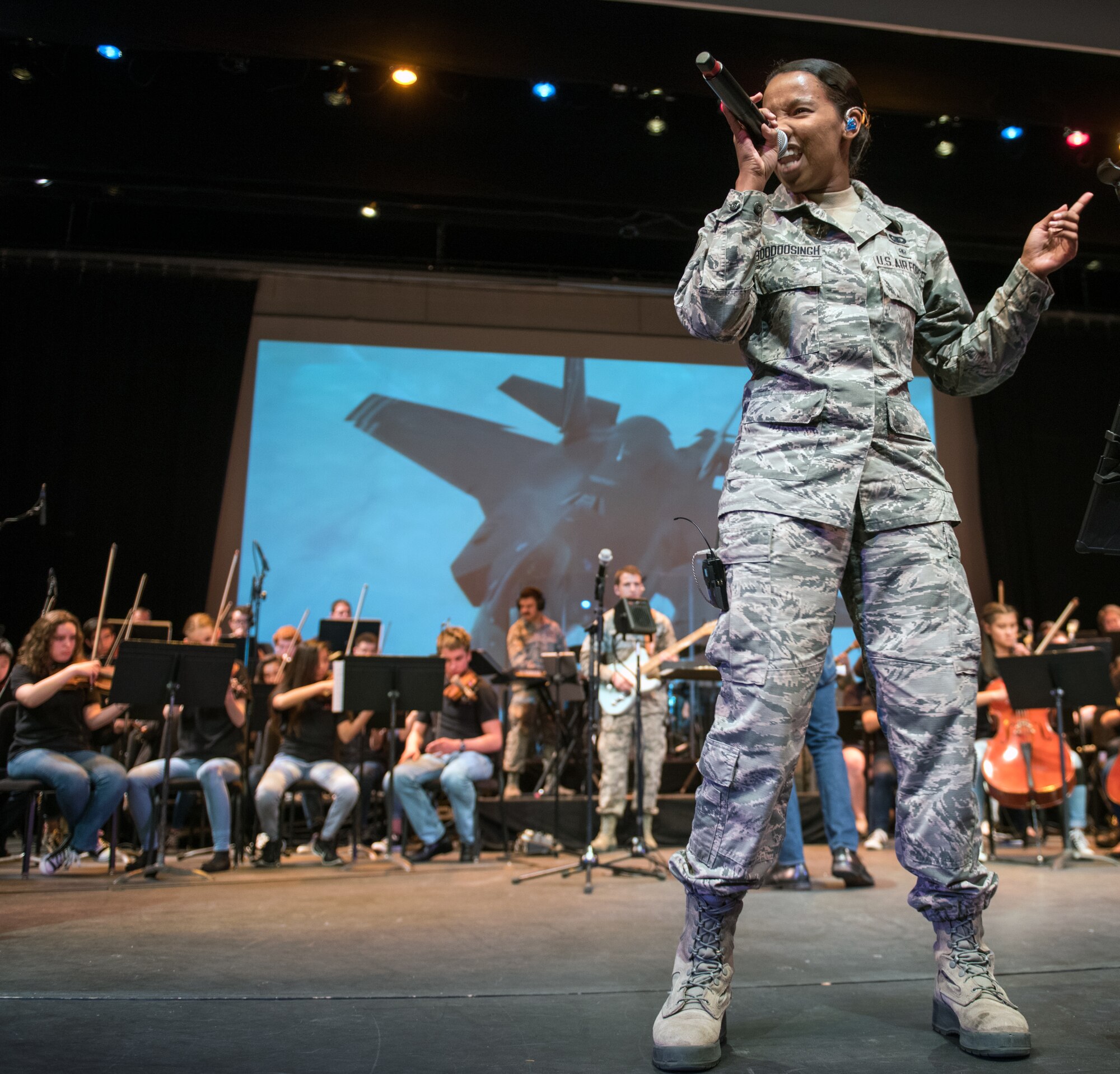 U.S. Air Force Senior Airman Salina Boodoosingh, a vocalist with the rock music group “Mobility” of The United States Air Force Band of the Golden West, Travis Air Force Base, Calif., performs with musicians from the Napa Valley Youth Symphony at the Veteran’s Home in Yountville, Calif., March 4, 2018. The band and symphony are performing together after the original concert, scheduled in October 2017, was canceled due to devastating wildfires in Napa and Sonoma counties. (U.S. Air Force photo by Louis Briscese)