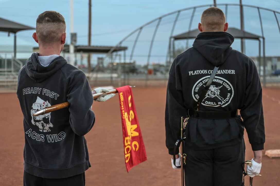 Captain Matthew S. Galadyk, platoon commander, U.S. Marine Corps Silent Drill Platoon, practices drill movements with a guideon bearer during the annual Battle Color Detachment training evolution at Marine Corps Air Station Yuma, Az., Feb. 21, 2018. The BCD consists of the Silent Drill Platoon, “The Commandant’s Own,” the United States Marine Drum & Bugle Corps and the Marine Corps Color Guard. The BCD conducts this training in order to refine and reform drill movements and performances for this upcoming West Coast Tour and 2018 parade season. (Official Marine Corps photo by Cpl. Damon A. Mclean/Released)