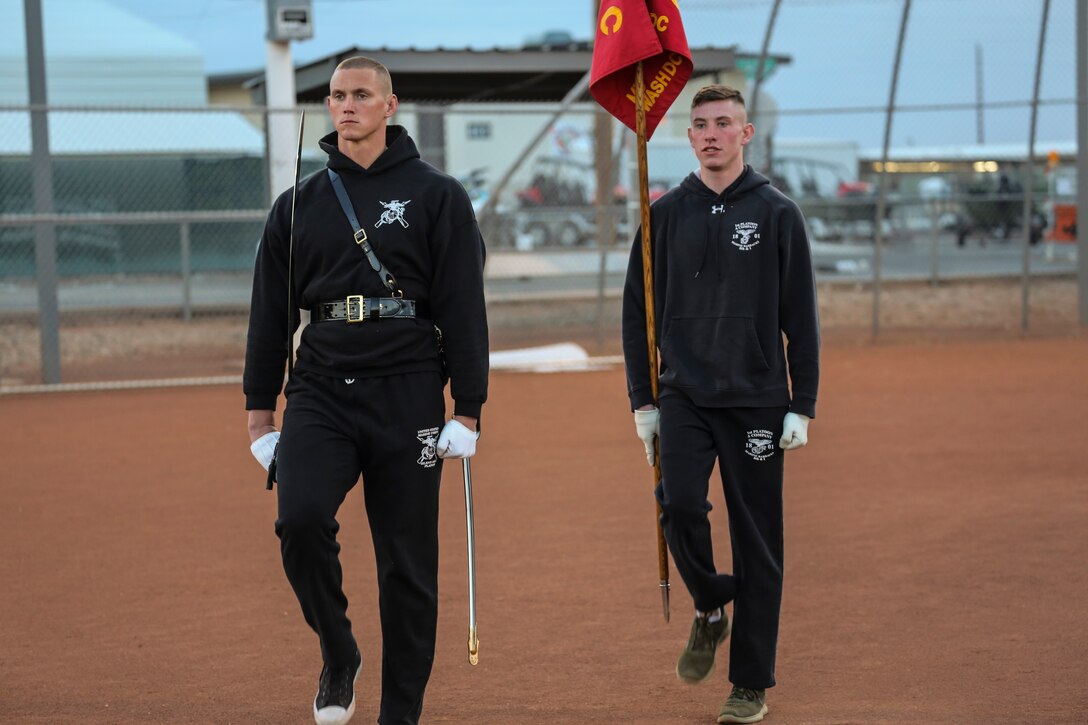 Captain Matthew S. Galadyk, platoon commander, U.S. Marine Corps Silent Drill Platoon, practices drill movements with a guideon bearer during the annual Battle Color Detachment training evolution at Marine Corps Air Station Yuma, Az., Feb. 21, 2018. The BCD consists of the Silent Drill Platoon, “The Commandant’s Own,” the United States Marine Drum & Bugle Corps and the Marine Corps Color Guard. The BCD conducts this training in order to refine and reform drill movements and performances for this upcoming West Coast Tour and 2018 parade season.(Official Marine Corps photo by Cpl. Damon A. Mclean/Released)