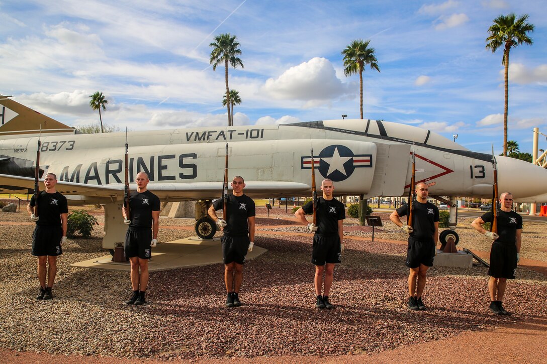Marines with the U.S. Marine Corps Silent Drill Platoon pose for a photograph in front of a McDonnell Douglas F-4B-6-MC “Phantom II” static display at Marine Corps Air Station (MCAS) Yuma, Az., Feb. 13, 2018. The Silent Drill Platoon traveled to MCAS Yuma to conduct their annual month-long training along with the other elements of the U.S. Marine Corps Battle Color Detachment (BCD). The BCD consists of the Silent Drill Platoon, “The Commandant’s Own,” U.S. Marine Drum & Bugle Corps, and the U.S Marine Corps Color Guard. (Official Marine Corps photo by Cpl. Damon Mclean/Released)