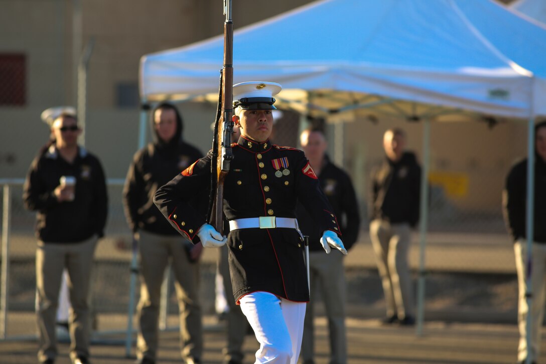 A Marine with the U.S. Marine Corps Silent Drill Platoon executes precision rifle drill movements while being evaluated during the platoon’s “Challenge Day” at Marine Corps Air Station Yuma, Az., Feb. 26, 2018. Each Marine performed the scripted throws, spins and drill movements while the drill master and rifle inspectors evaluated the Marines to choose the rifle inspection team for 2018 parade season.  The Marines were chosen based on several factors; including bearing, uniforms, and proficiency.(Official Marine Corps photo by Cpl. Damon A. Mclean/Released)