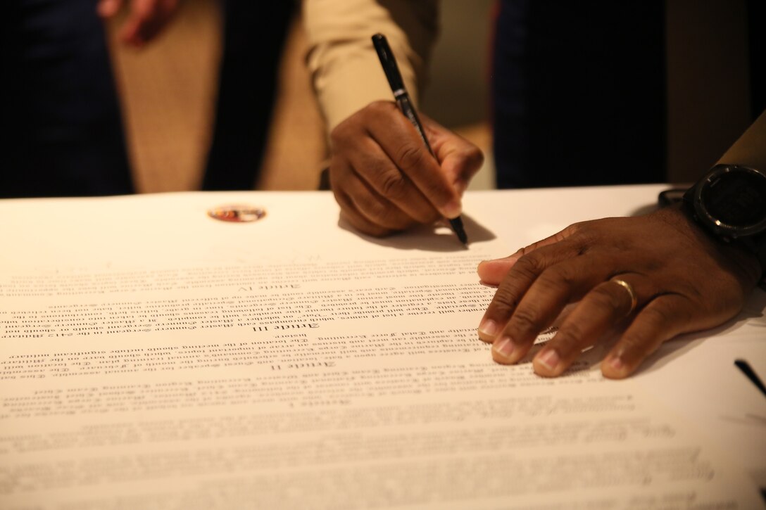 NEW YORK CITY – Master Gunnery Sgt Eric R. Miller signs the newly created Constitution of the Gray Beards Society at the National 8412 Gray Beards Symposium at the Millennium Hilton New York Downtown in New York City, Feb. 21. Marine Corps Recruiting Command (MCRC) conducts annual training to assure the continued professional development of the recruiting force. Part of a Gray Beards’ role is to observe, diagnose, and identify what is needed to help the recruiting force achieve peak total force recruiting performance. Miller is the chief instructor at Marine Corps Recruiters School. (U.S. Marine Corps photo by Sgt. Paul T. Williams III)
