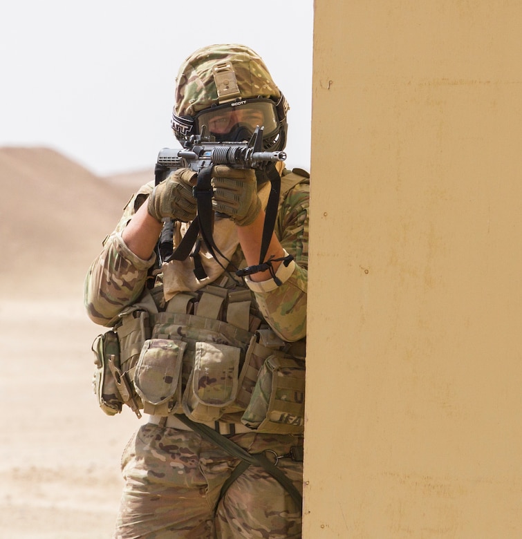 An artilleryman in Delta Battery, 1st Battalion, 145th Field Artillery Regiment, fights from cover during a simulated firefight as a part of urban operations training at a base near Camp Buehring, Kuwait, Feb. 28, 2018.