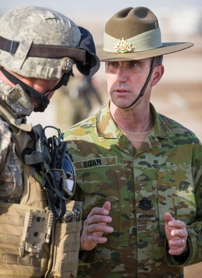 Australian soldiers speaking to each other.