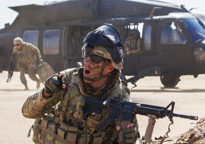 Sergeant 1st Class Aaron Sanford, a maintenance supervisor, Delta Battery, 1st Battalion, 145th Field Artillery Regiment, gives commands to his platoon following their departure from a UH-60 Black Hawk near Camp Buehring, Kuwait, Feb. 28, 2018.