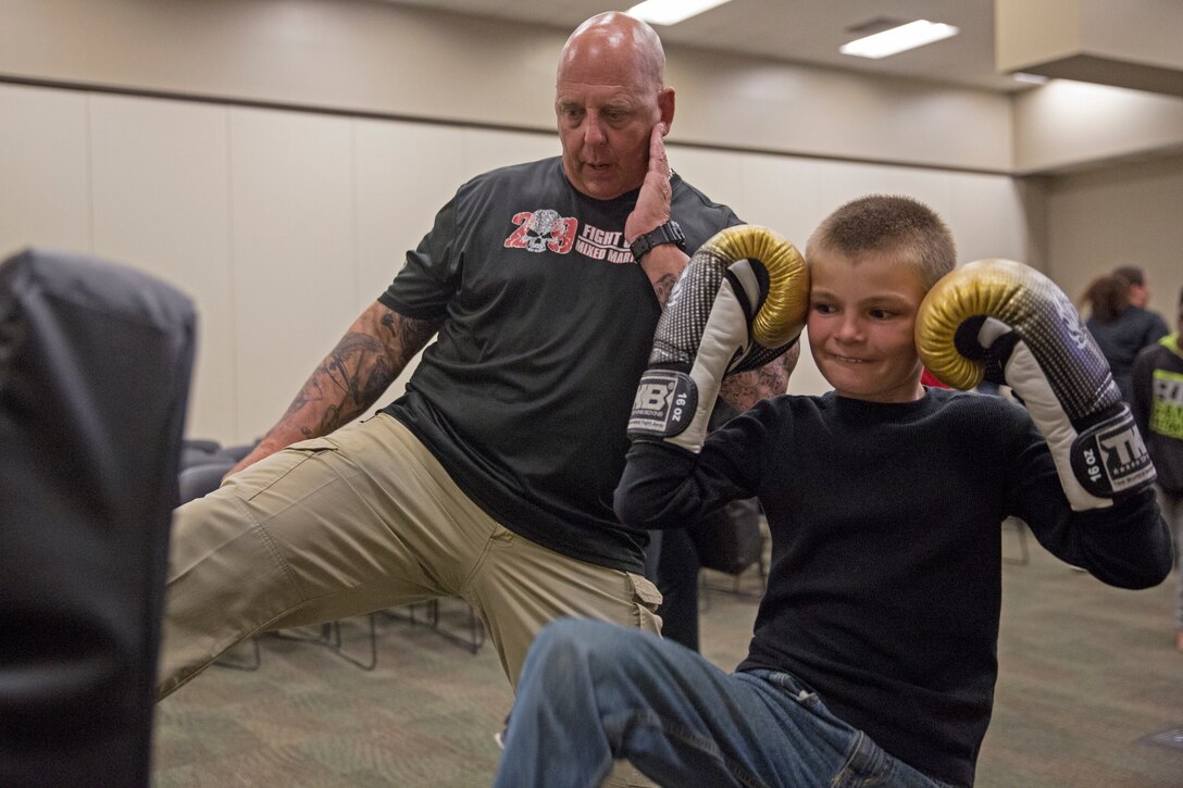 Mark Gletko, the boxing coach for the installation’s Mixed Martial Arts Fight Club 29, teaches practical application during  a self defense class as part of Teen Dating Violence Awareness month in building 1707 aboard the Marine Corps Air Ground Combat Center, Twentynine Palms, Calif., Feb. 22, 2018. The class was held to give parents and their children the opportunity to learn how to defend themselves in a dangerous situation. (U.S. Marine Corps photo by Lance Cpl. Jennessa Davey)