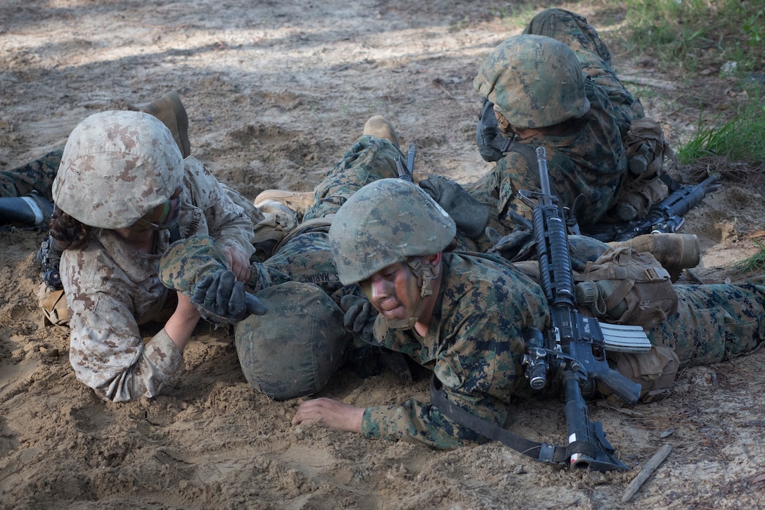 U.S. Marine Corps recruits with Oscar and Golf Company, Recruit Training Regiment, do buddy drags while conducting the Combat Endurance Course on Parris Island, S.C. on May 20, 2017.