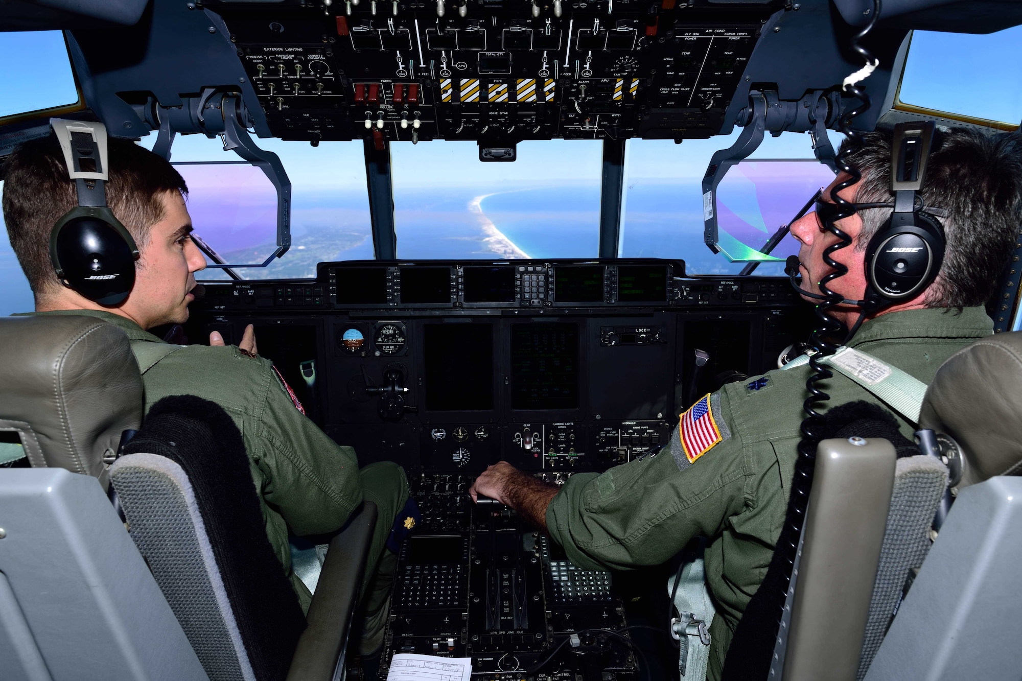 Lt. Col. Scot Salminen (right) and Maj. Kevin Olsen, 815th Airlift Squadron pilots, discuss the flight path of their C-130J Super Hercules aircraft March 2 during Emerald Warrior 2018. The 815th AS “Flying Jennies” provided airlift support for the special operations joint training event at Hurlburt Field, Florida, Feb. 26-March 2. The exercise involved units from all U.S. military branches, U.S. Special Operations Command and North Atlantic Treaty Organization partner forces. (U.S. Air Force photo by Tech. Sgt. Ryan Labadens)
