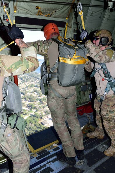 Special Forces members prepare to jump out the side door of a C-130J Super Hercules aircraft March 2 during Emerald Warrior 2018. The 815th AS “Flying Jennies” provided airlift support for the special operations joint training event at Hurlburt Field, Florida, Feb. 26-March 2. The exercise involved units from all U.S. military branches, U.S. Special Operations Command and North Atlantic Treaty Organization partner forces. (U.S. Air Force photo by Tech. Sgt. Ryan Labadens)