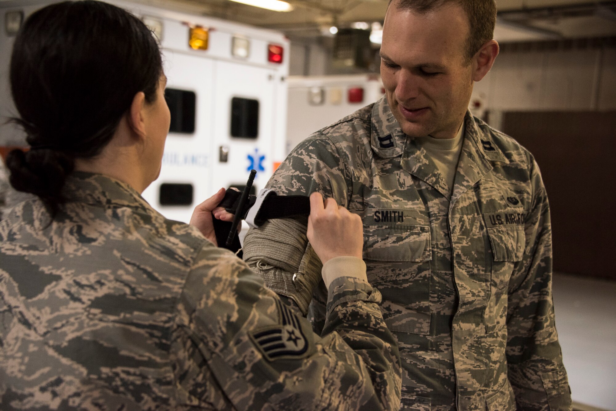 419th Fighter Wing reservist Staff Sgt. Erin Mills places a tourniquet on Capt. Trevor Smith during a Self-Aid and Buddy Care refresher class
